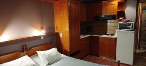 a small kitchen with a bed in a room at Vrachos Κanari in Kiveri