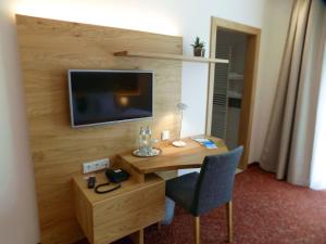Pokój z biurkiem i telewizorem na ścianie w obiekcie Mostlandhof w mieście Purgstall