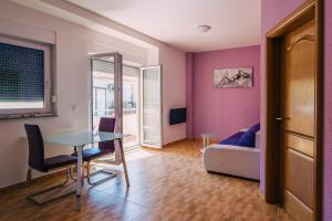 a living room with a table and a couch at Luxur house with seaview teracce in Baška Voda