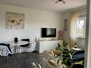 a living room with a tv and a table and chairs at Mila in Vodnjan