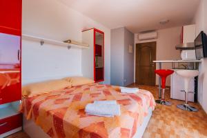 a bedroom with a bed with towels on it at Luxur house with seaview teracce in Baška Voda