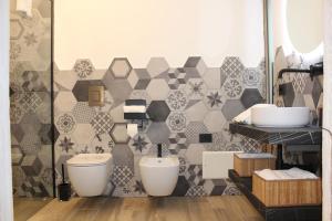a bathroom with two sinks and a tiled wall at La Moretta Suite rustic apartment in Negrar +25 photos