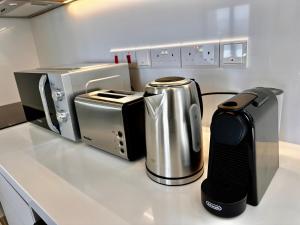 a kitchen counter with a coffee maker and a toaster at Santa Barbara Sea front resort and spa in Polis Chrysochous