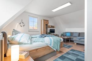 a bedroom with a bed and a living room at Gertruds Leuchtturm Strandnah in Zingst