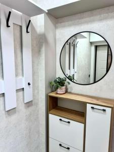 a bathroom with a mirror on the wall at Квартира 4-40 in Balqash
