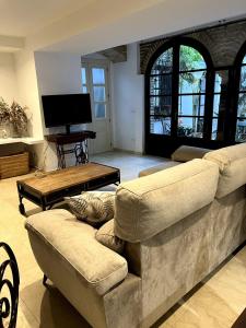 a living room with two couches and a television at La casa del Retablo in Córdoba