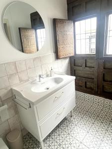 a bathroom with a white sink and a mirror at La casa del Retablo in Córdoba +90 photos