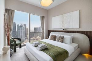 a bedroom with a large bed and a large window at Bella Elite Homes at Grande Signature Burj and Fountain Great Full View- Brand New Luxury Apartement in Dubai +43 photos