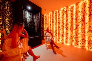 two women sitting in front of a wall of lights at Rezydencja Pod Pieprzówkami in Zalesie Gorzyckie +125 photos