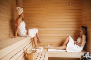 two women sitting in a sauna at Rezydencja Pod Pieprzówkami in Zalesie Gorzyckie