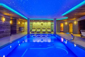 a swimming pool in a house at night at Boutique Hotel ERB - Adults Only in Banská Štiavnica