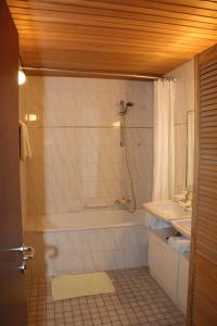 a bathroom with a tub and a sink at Apart Gipfelstürmer in Landeck