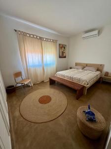 a bedroom with a bed and a large rug at Appartement Cascade in Saly Portudal