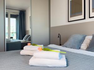 a bedroom with a bed with towels on it at URBAN APARTMENTS PREMIUM, Opolska 10 No 91, Free Garage, Self Check-in in Katowice