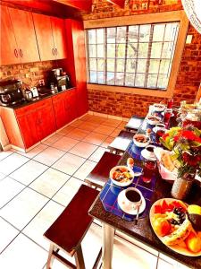 a kitchen with a table with plates of food on it at Ingwenya View in Marloth Park