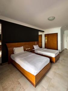 a bedroom with two beds and a black wall at DeltaStar in Sharm El Sheikh