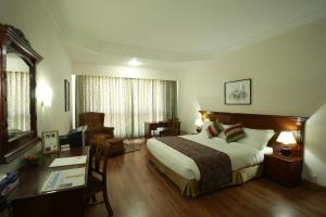 A bed or beds in a room at Hotel Pokhara Grande