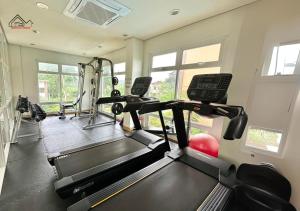 a fitness room with a treadmill and a gym at Condo in Puerto Princesa in Puerto Princesa City