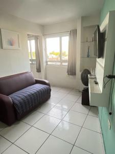 a living room with a couch and a window at Recife - Boa Vista in Recife