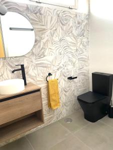 a bathroom with a toilet and a sink and a mirror at Soleado 2 - A 8 min a pie de la playa San Lorenzo in Gijón +19 photos