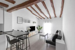 a living room with a table and a couch at Alcoy Old Town - Reformed Penthouse with AC and wifi in Alcoy