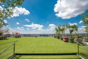 a large green field with trees and a blue sky at Skynest Residences, 10th floor, Room 1017. in Nairobi