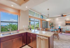 a kitchen with a sink and a large window at 1614 Ridge in Kahana