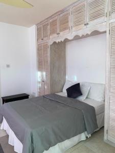 a bedroom with a large bed with wooden cabinets at PortzVue Villa in Saint Peter