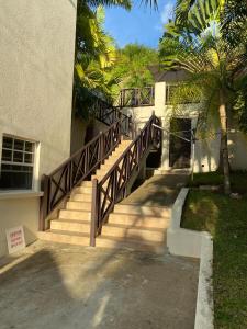 a stairway leading up to a building with a wooden railing at PortzVue Villa in Saint Peter
