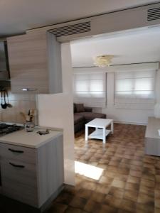 a kitchen and living room with a couch and a table at Appartamento Zona ospedale in Treviso