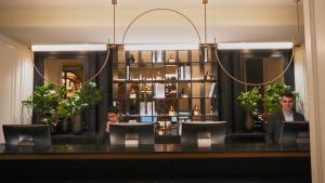 a couple of people sitting at a counter in a restaurant at Hotel Regina in Madrid