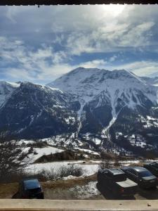 a group of cars parked on top of a snow covered mountain at T3 Orcières 8 personnes in Orcières