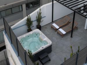 a hot tub on the roof of a building at Vision Gazi in Athens