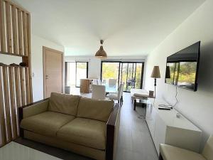 a living room with a couch and a table at Villa Favone 3 in Favone