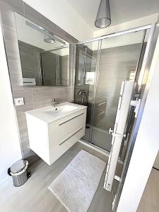 a bathroom with a white sink and a shower at Villa Favone 3 in Favone