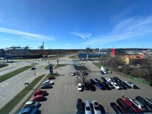 a parking lot with a bunch of parked cars at Green Park Hotel Klaipeda in Klaipėda