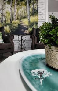 a tub with a picture of a deer in the water at Eland Rus Micro Stay Self Catering in Kathu