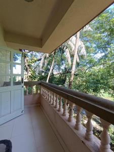 a balcony with a view of the trees at Ourgoaholidays 1st floor Candolim in Candolim