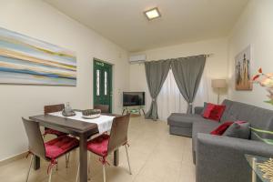 a living room with a table and a couch at Lucia's Home in Stalos