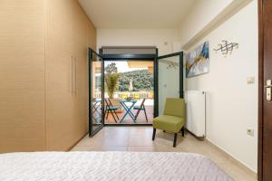 a bedroom with a door leading to a patio at Lucia's Home in Stalos +47 photos