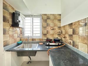 a kitchen with a sink and a counter top at 1Bhk in Hennur 1st floor near Bhartiya city 101 in Bengaluru +15 photos