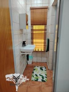 a bathroom with a sink and a mirror at Eland Rus Micro Stay Self Catering in Kathu