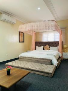 a bedroom with a large bed with a canopy at Les HOTELS TALHAYA, NOUAKCHOTT in Nouakchott