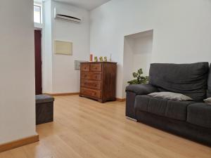 a living room with a couch and a dresser at Casa das Amas do Cardeal in Évora +2 photos
