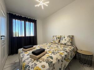 a small bedroom with a bed and a window at Appartement 300m de la mer in Valras-Plage