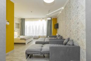 a room with a row of couches in a room at Opera Passage Hotel & Apartments in Lviv