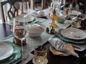 a table with plates and wine glasses on it at Riverbed Africa in Lydenburg +21 photos