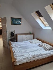 a bedroom with a large bed with white sheets at Duże mieszkanie w Kostkowie in Kostkowo +9 photos