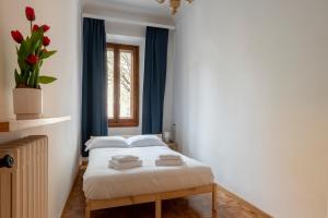 a bed in a room with blue curtains and a window at Eventi e Relax vicino all'Artemio Franchi e al Centro Storico in Florence