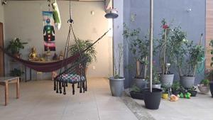 a room with a hammock and a bunch of potted plants at Lindo apartamento centro barra mansa in Barra Mansa